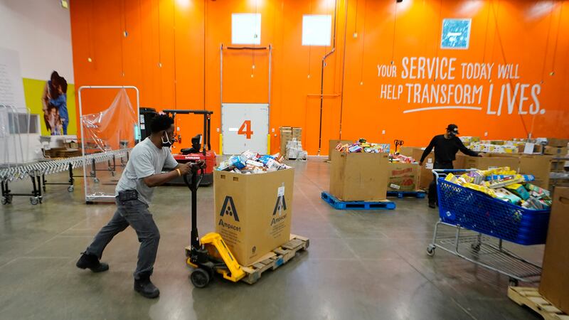 Volunteer group leader Bruce Beecham works to sort food items in the Atlanta Community Food...